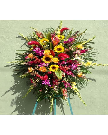 Large colorful standing floral spray with sunflowers and orchids
