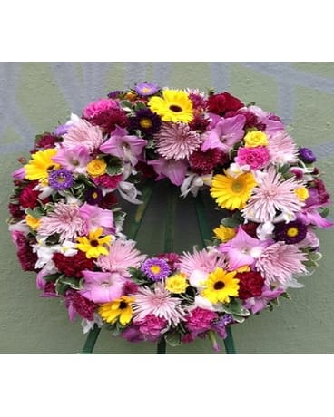 Colorful floral wreath with pink, yellow, purple, and white flowers
