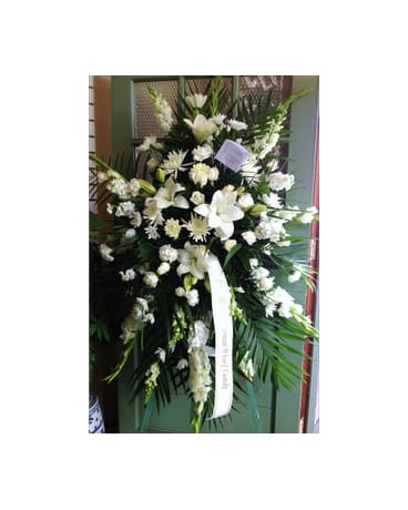Tall white floral standing spray with a ribbon