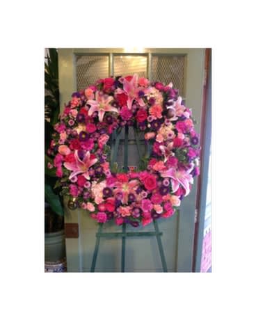 Large pink and purple floral wreath on an easel