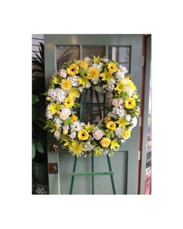 Yellow and white floral wreath on an easel