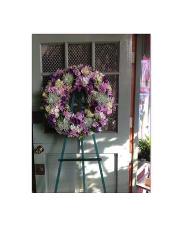 Purple and pink floral wreath on a standing easel