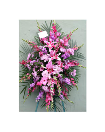 Pink and purple standing floral spray with lilies and carnations