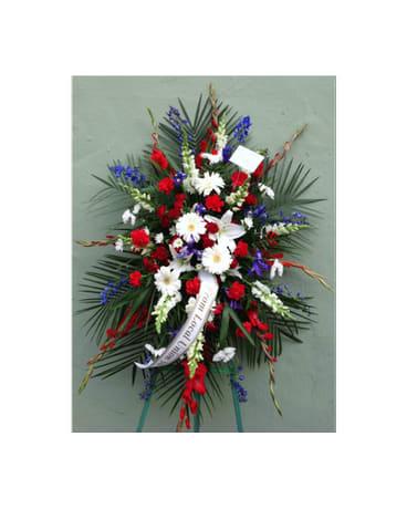 Standing funeral spray with red, white, and blue flowers