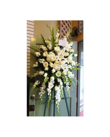 Tall white floral standing spray on an easel