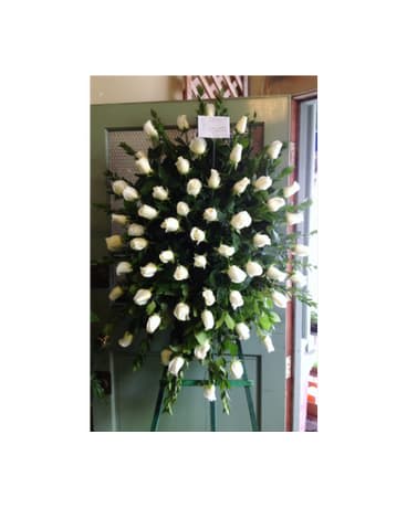 Large standing spray of white roses on an easel
