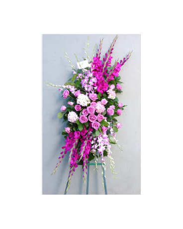 Tall pink and white floral standing spray on a metal easel