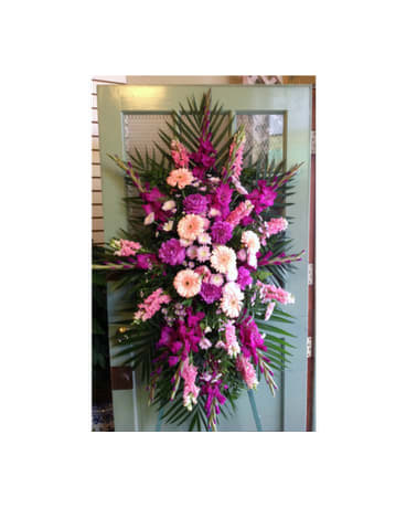 Tall pink and peach floral standing spray with palm fronds