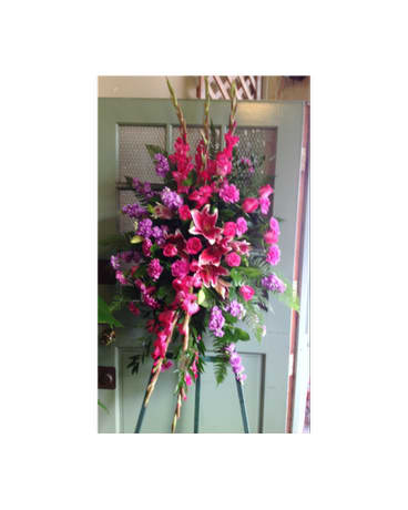 Tall pink and purple floral standing spray on an easel