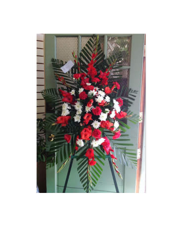 Standing floral spray with red and white flowers on an easel