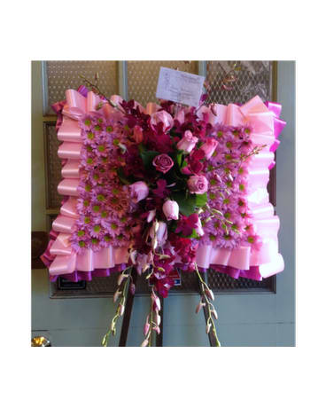 Pink and magenta floral standing spray with ribbon trim