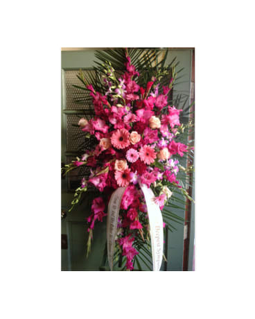 Tall pink floral standing spray with ribbon streamers