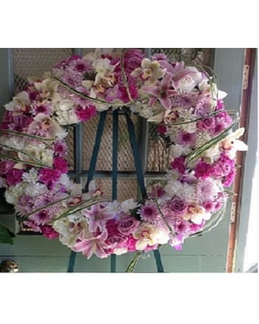 Pink and white floral wreath on a stand