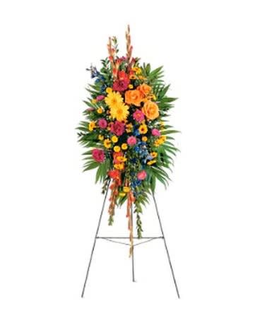 Standing floral spray with bright mixed flowers on an easel