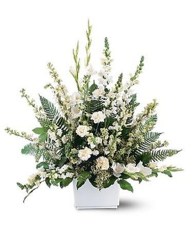White floral arrangement in a white rectangular vase