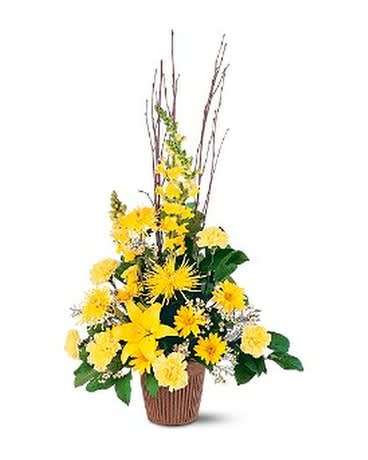 Tall yellow floral arrangement in a brown basket with branches