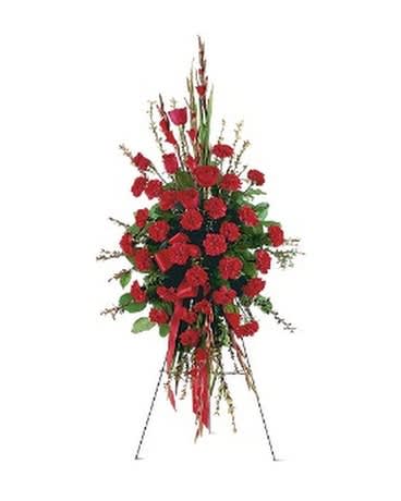 Tall standing spray of red carnations with ribbon on an easel
