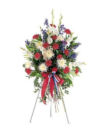 Standing floral spray with red, white, and blue flowers on an easel