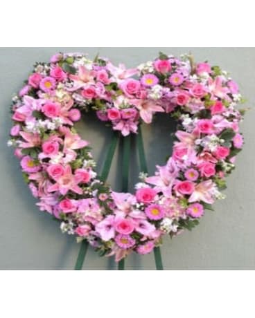 Heart-shaped pink floral wreath with ribbon tails