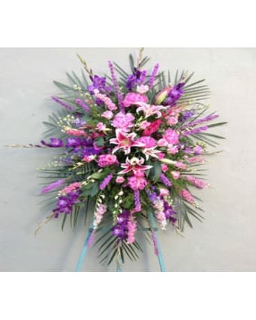 Large pink and purple standing floral spray with lilies and carnations