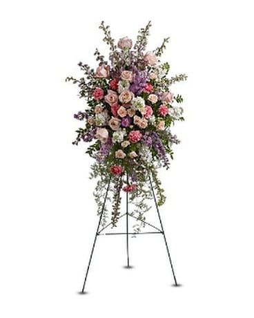 Tall standing floral spray with pink and purple blooms on a metal easel