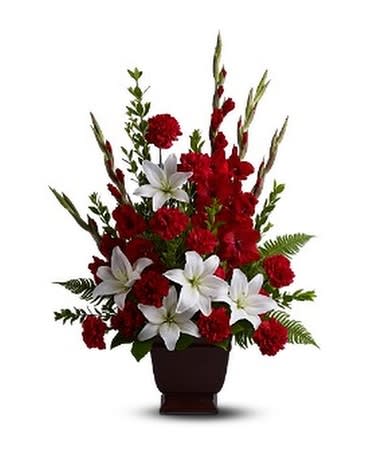 Red and white floral arrangement in a dark vase