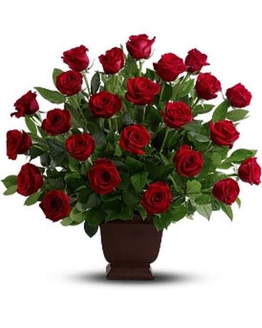 Arrangement of red roses in a brown urn vase
