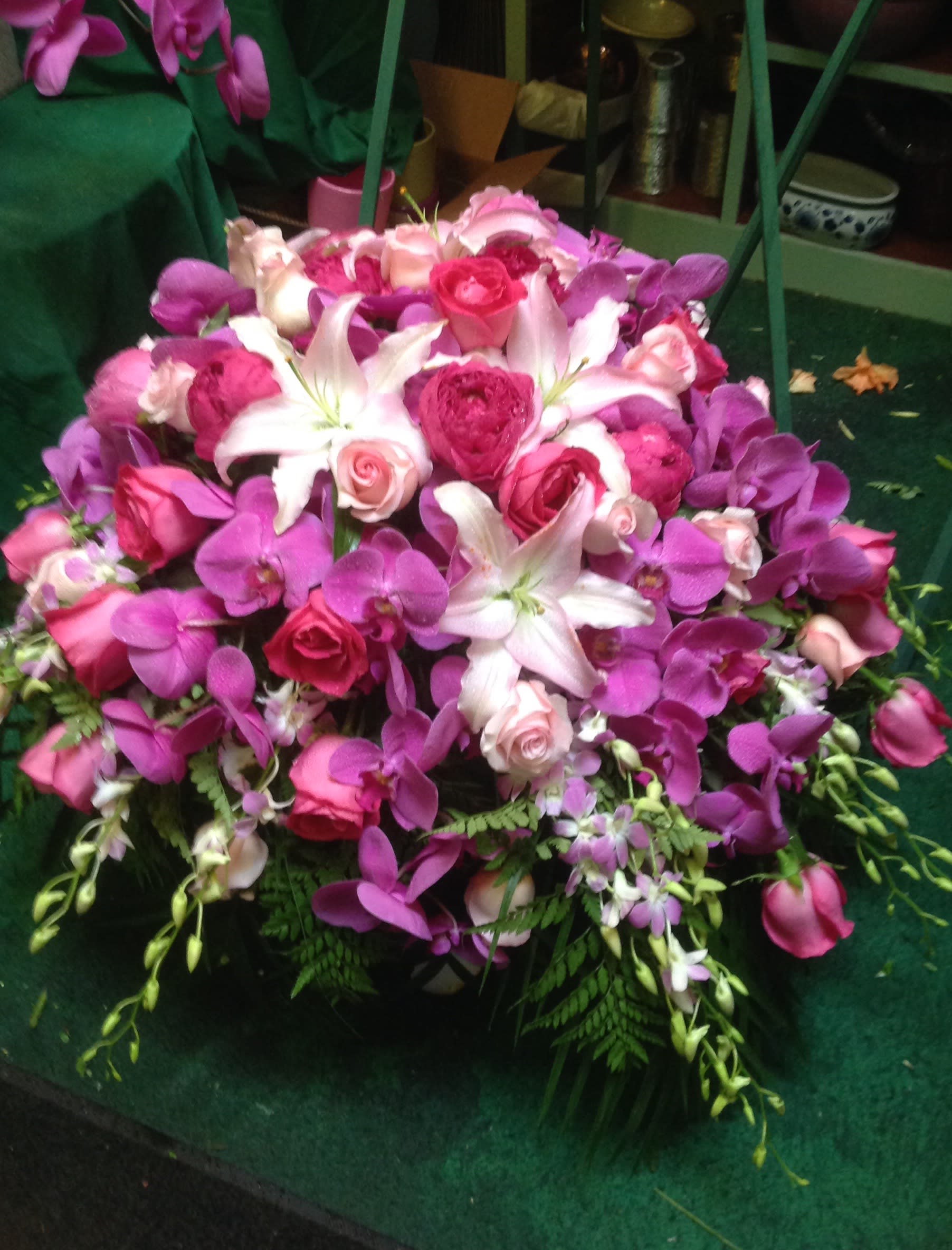 Pink and purple bouquet with white lilies and roses