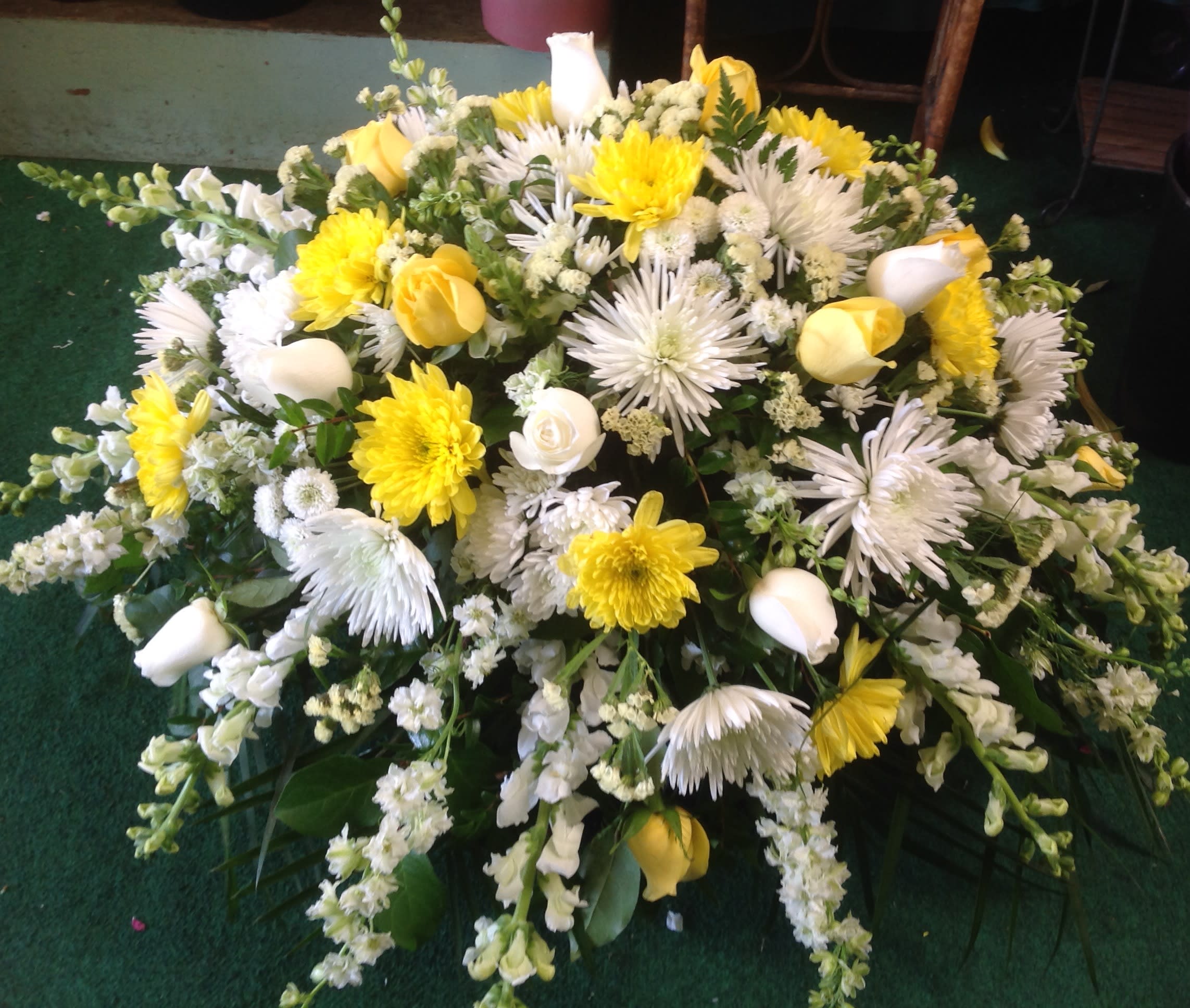Yellow and white floral spray with mixed blooms and white calla lilies