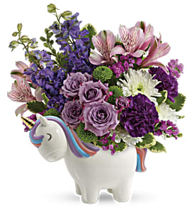 Bouquet of purple and pink flowers in a unicorn-shaped vase
