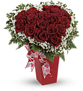 Red rose bouquet in a red box with a heart ribbon