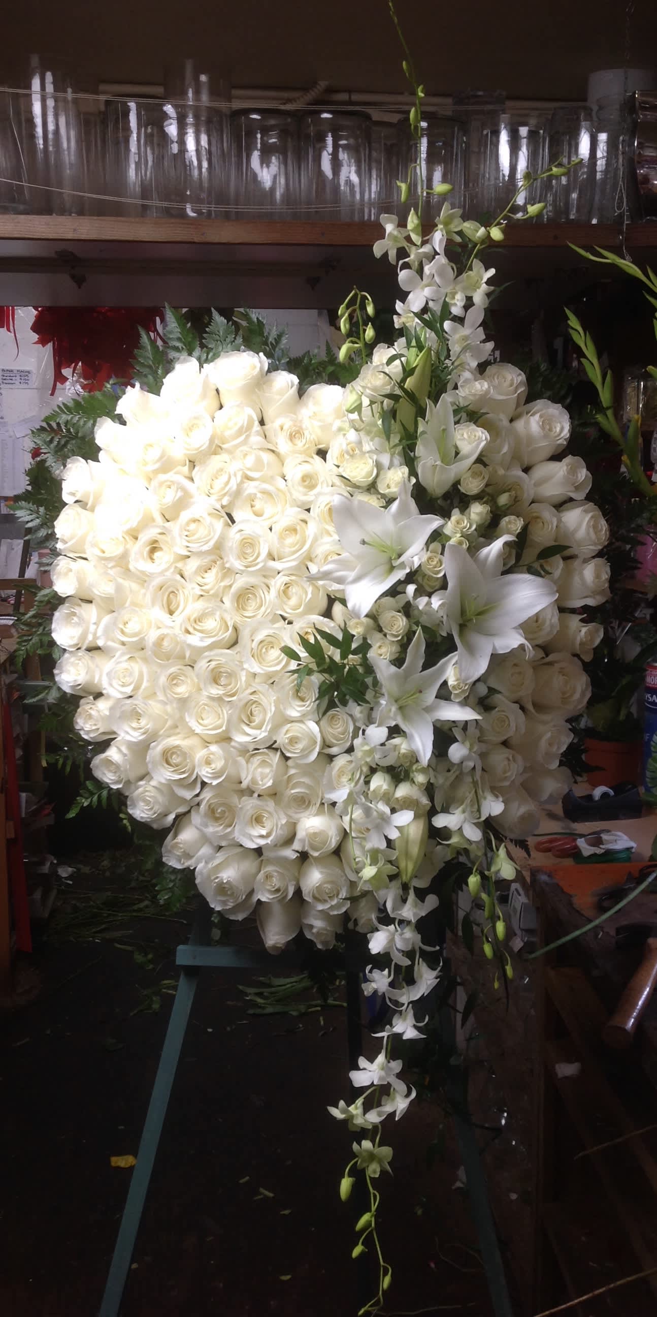 Large white rose and lily floral spray with cascading orchids