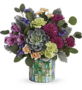 Mixed bouquet with succulents and purple flowers in a mosaic vase