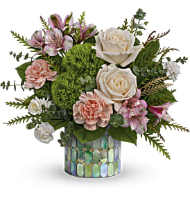 Bouquet of pink and white flowers in a mosaic glass vase