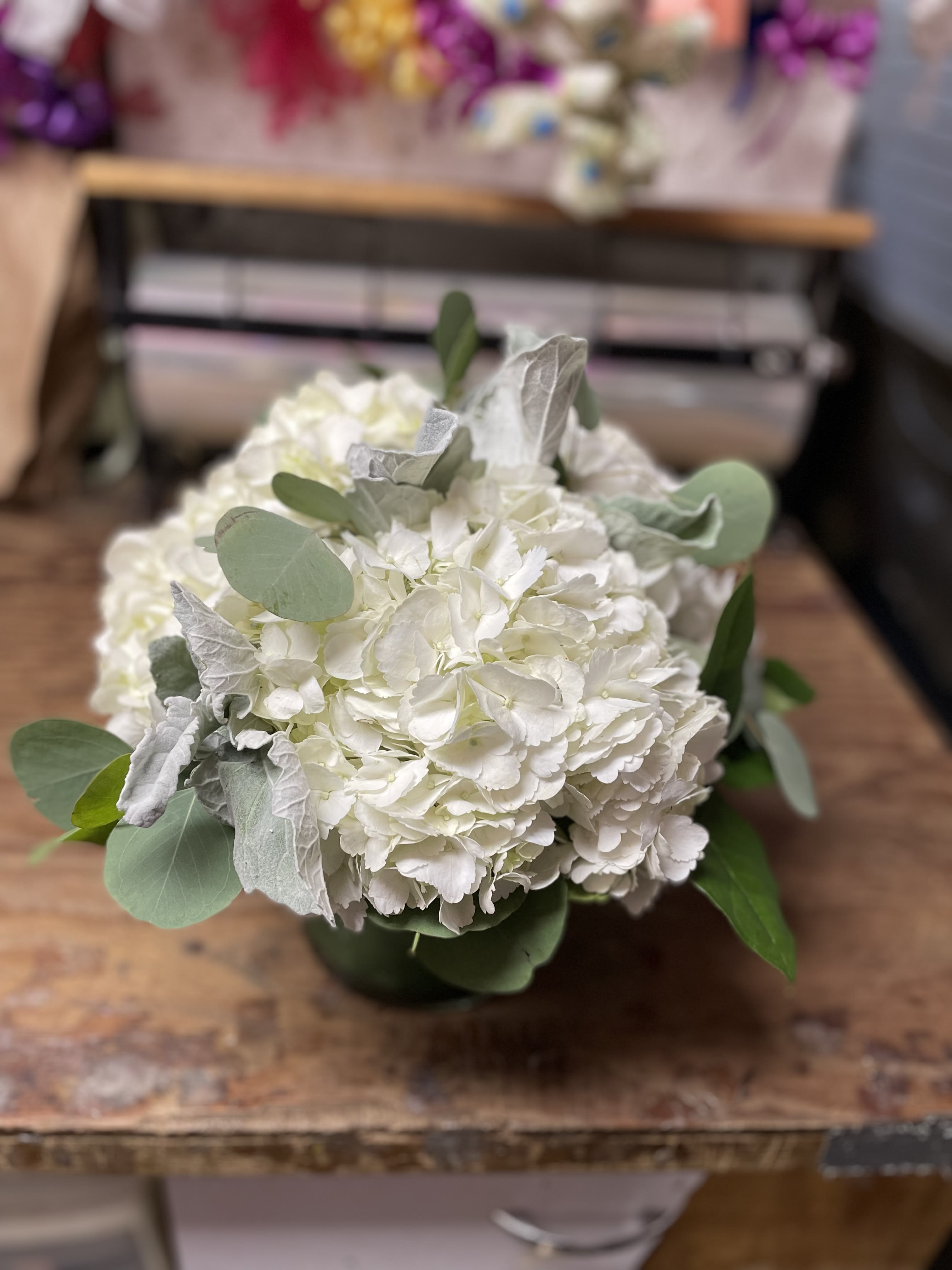 White hydrangea bouquet with eucalyptus in a vase
