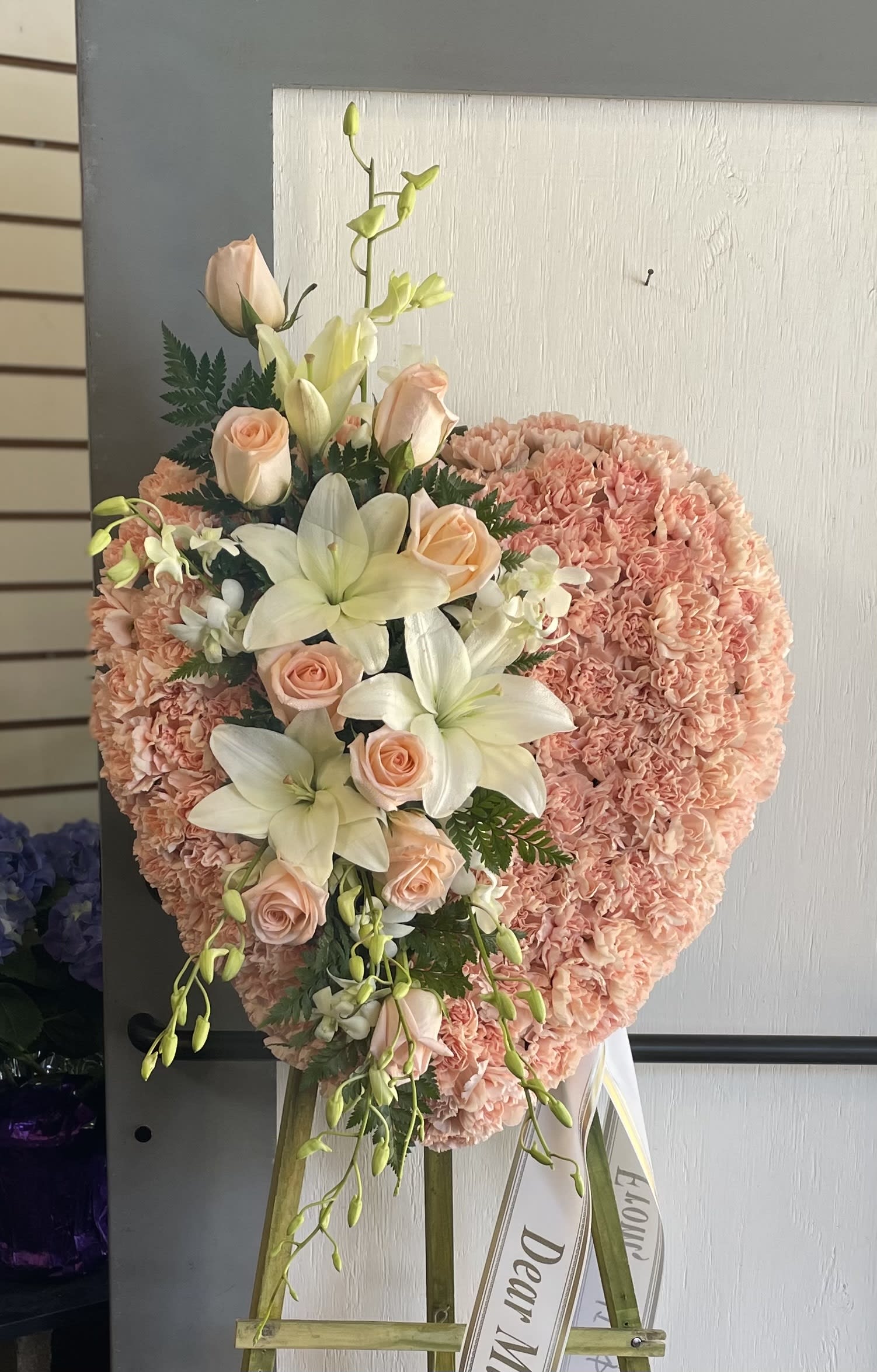 Heart-shaped pink floral standing spray with roses and lilies
