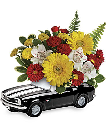 Bouquet of red, yellow, and white flowers arranged on a black toy car
