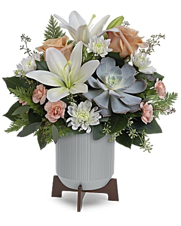 Arrangement of white lilies, peach roses, and daisies in a ribbed vase