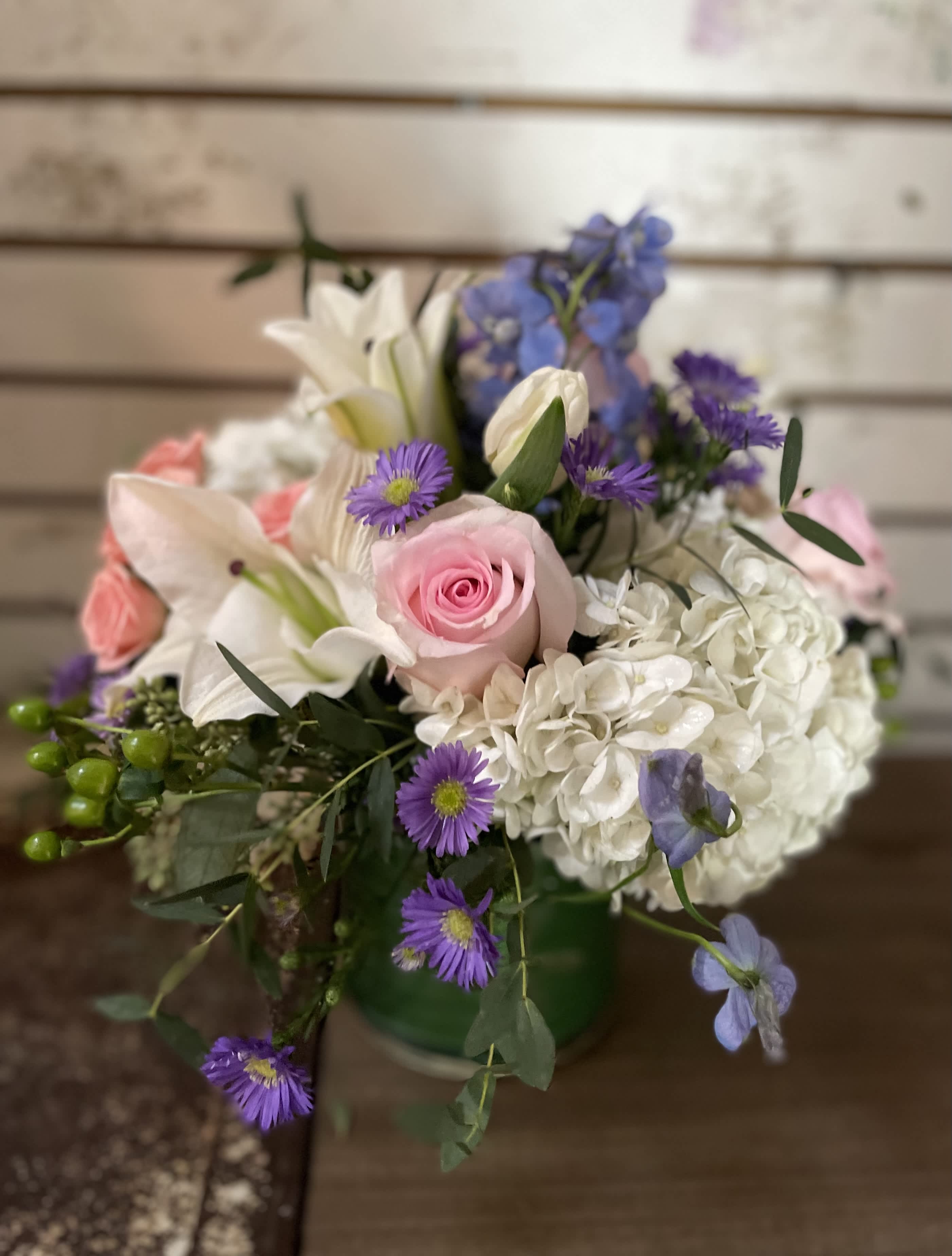 Mixed bouquet with pink roses, white lilies, and purple flowers