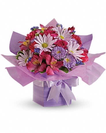 Compact bouquet of pink and lavender flowers in a lavender gift box with matching ribbon