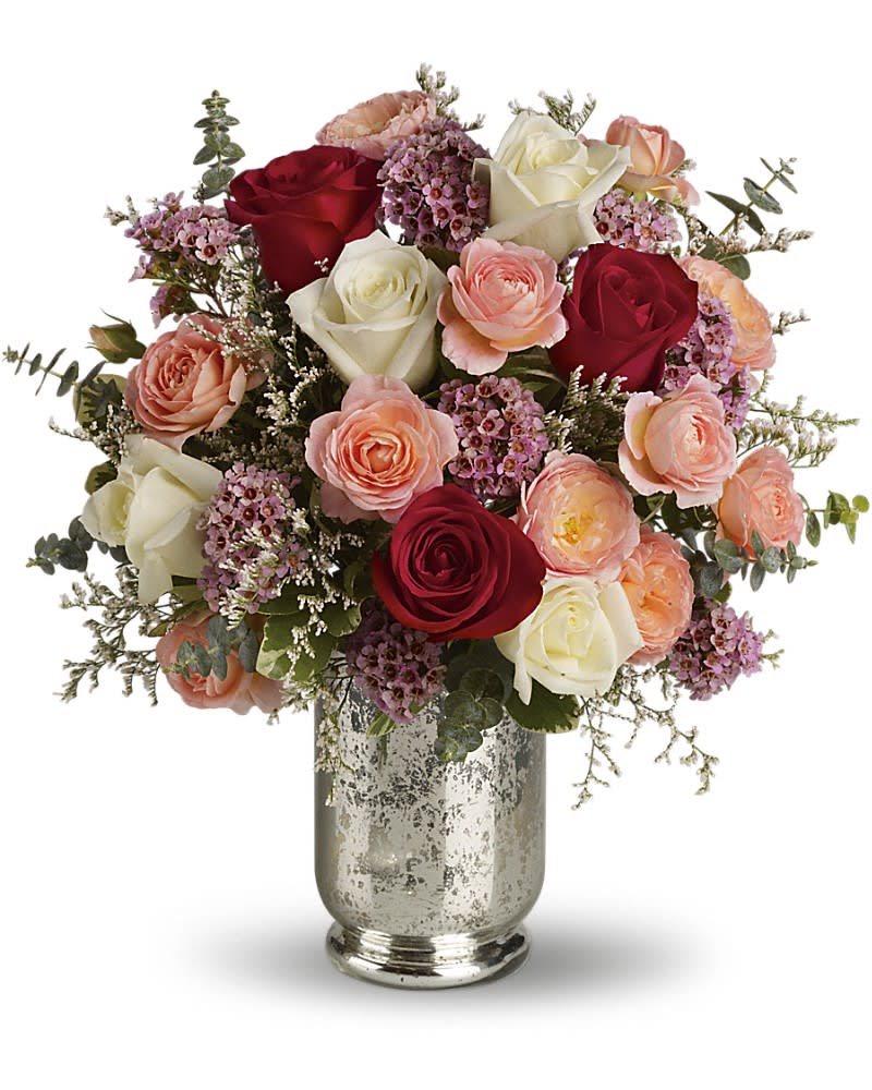 Bouquet of red, white, and peach roses in a silver vase