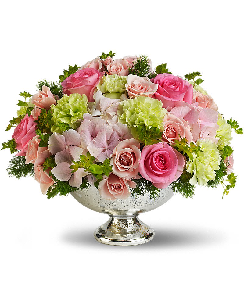 Pink and blush roses with green carnations in a silver pedestal bowl