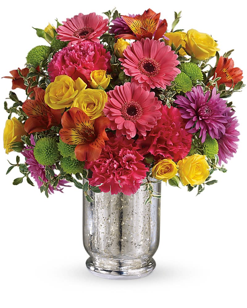 Mixed bouquet of pink, yellow, orange, and purple flowers in a silver vase