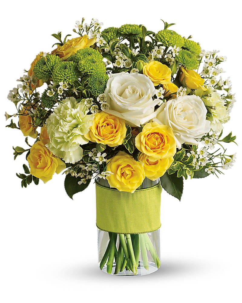 Bouquet of yellow and white roses with green pompon mums in a glass vase