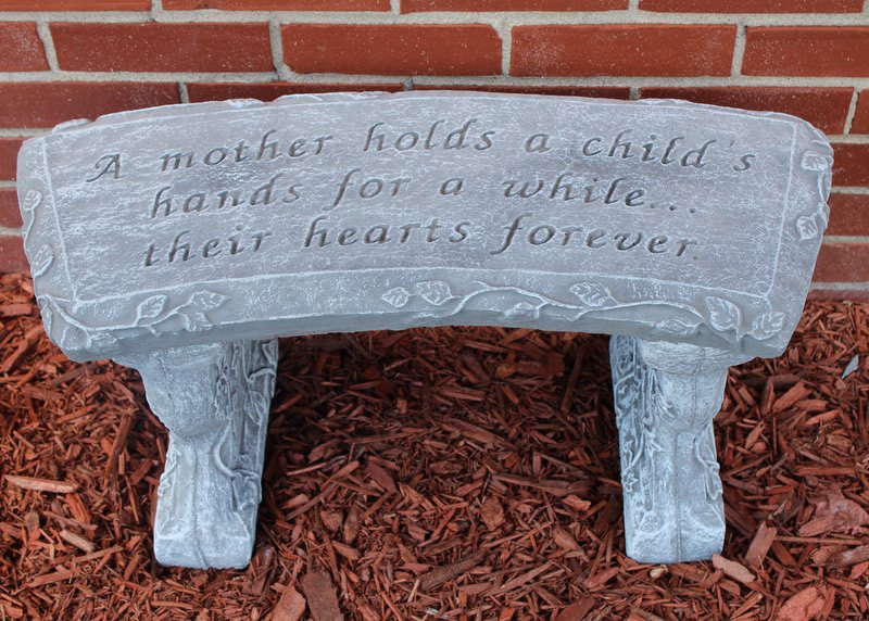Stone bench with an engraved mother-and-child quote