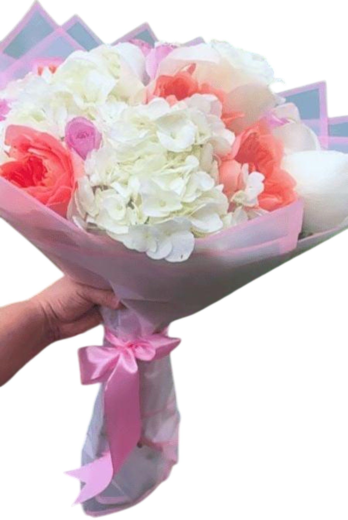Pink and white bouquet wrapped in translucent paper with a ribbon