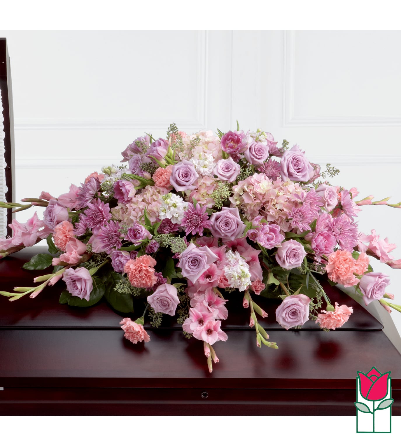 Large pink and lavender floral casket spray with roses and carnations