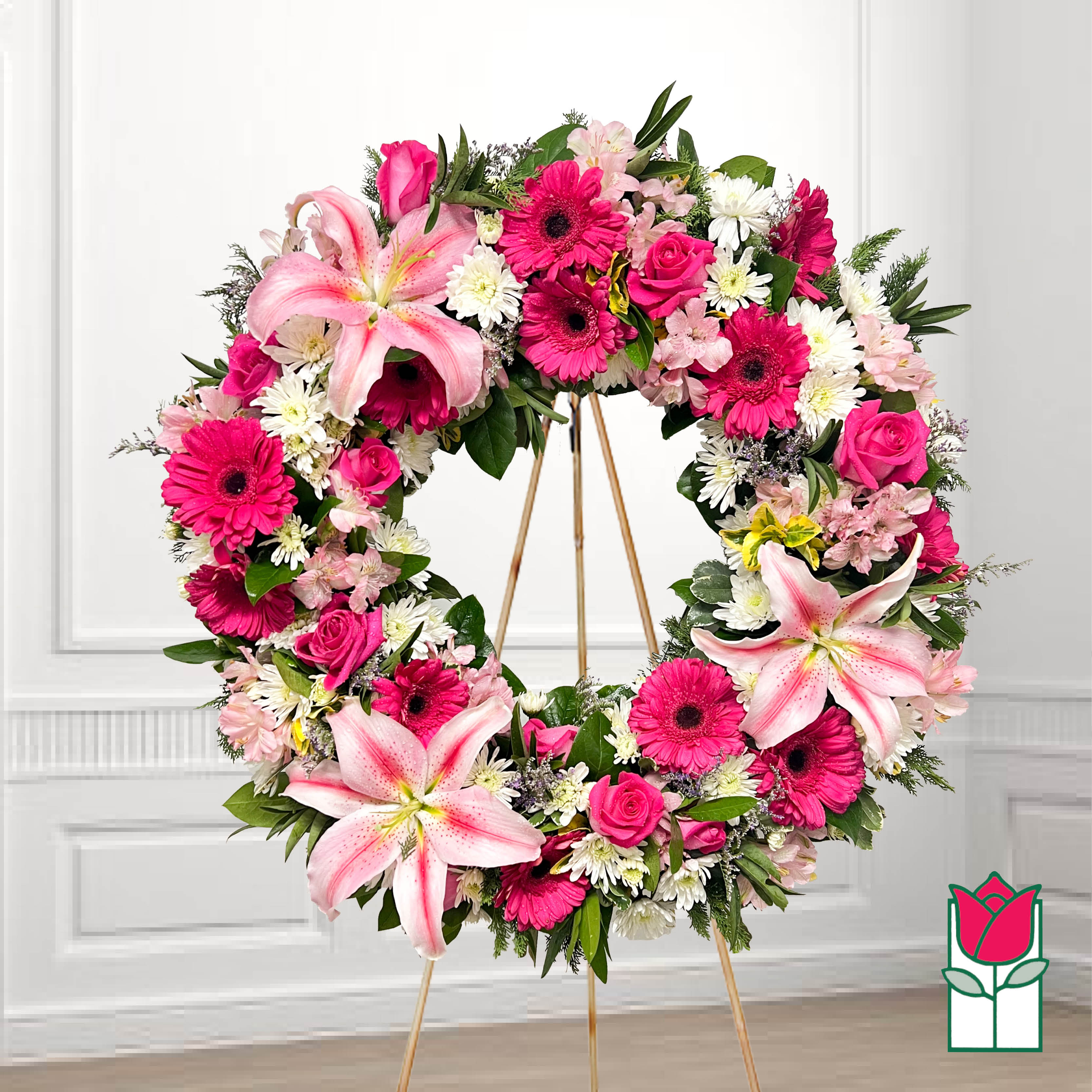 Pink and white floral wreath on a gold easel