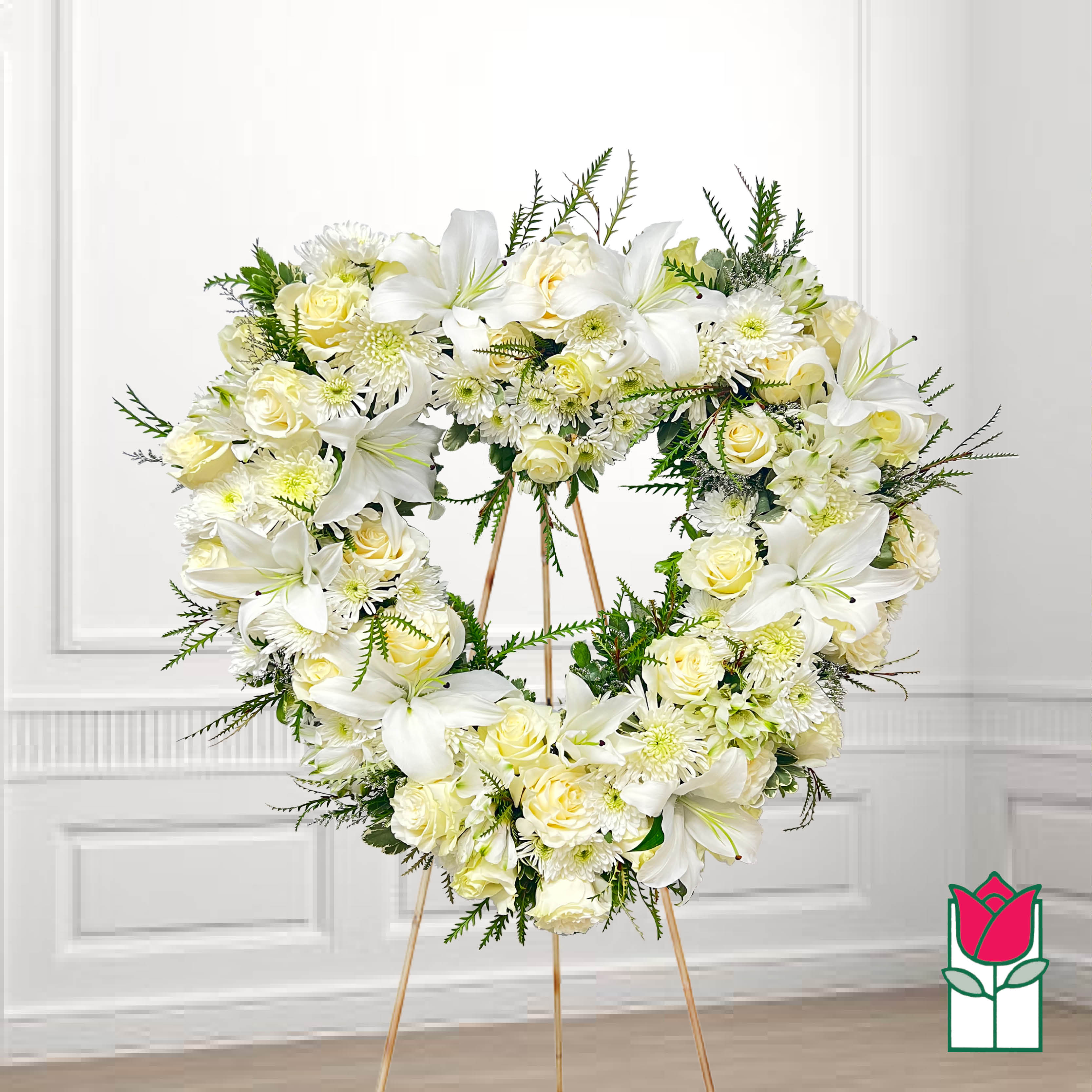 Heart-shaped white floral wreath on a stand