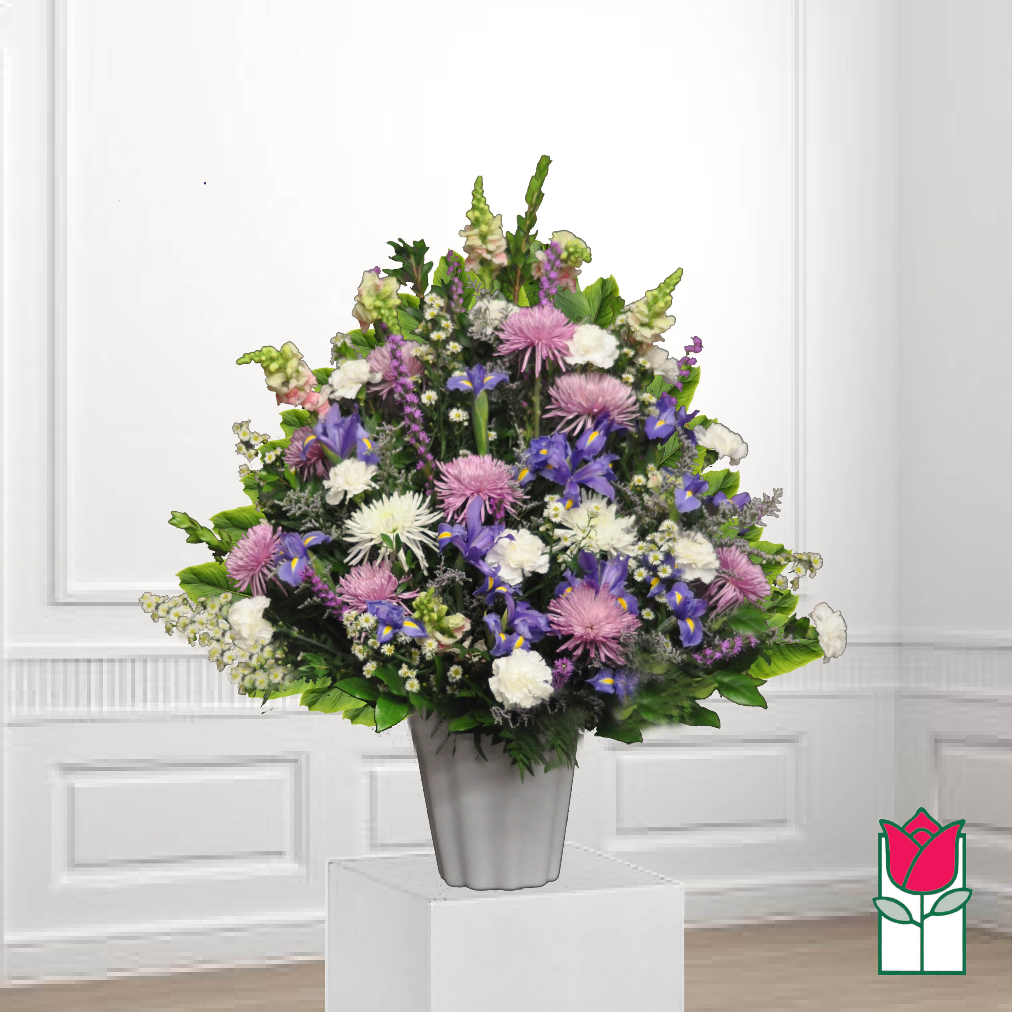 Mixed purple and white floral arrangement in a silver vase